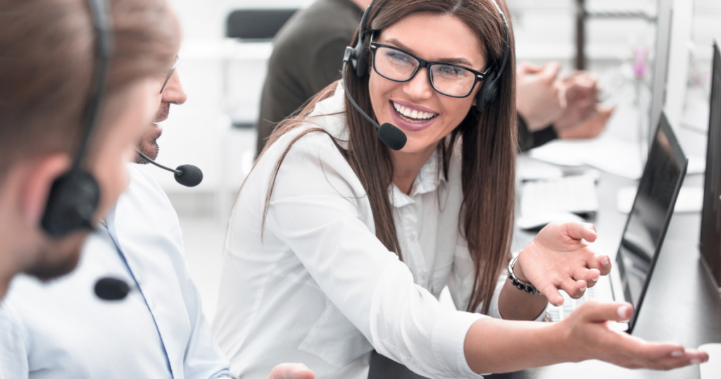 How to Activate Staff-Driven CX Solutions and Results - happy contact center employee gesturing at computer screen