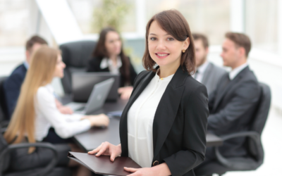 How to Improve Customer Service in Your Bank's Contact Center. A successful business woman stands in front of her team.