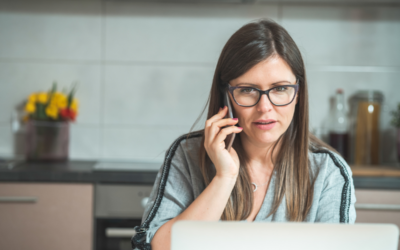 What Are You Missing from Your Call Monitoring? A woman with glasses has a concerned expression on her face as she talks on her phone to customer service reps.