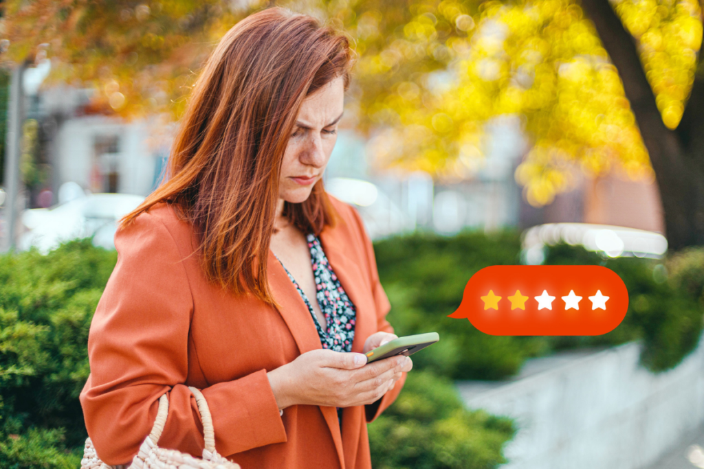 Bad Customer Reviews? Here's What You Can Do: an upset woman outside leaves a 2 star review